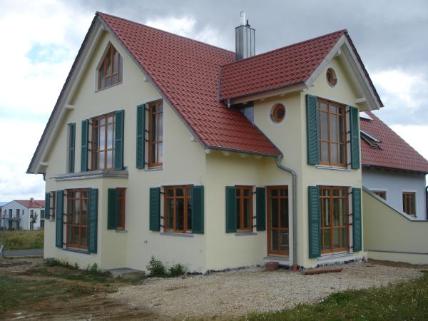 Holzfenster mit grünen Klappläden 